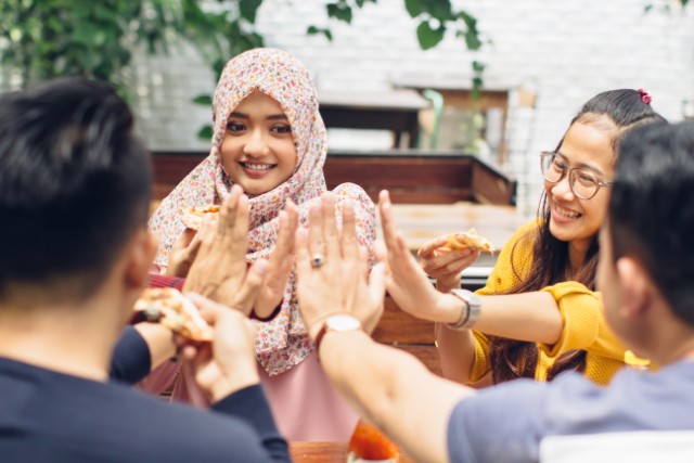 a group of asian teenagers of mixed races sitting together