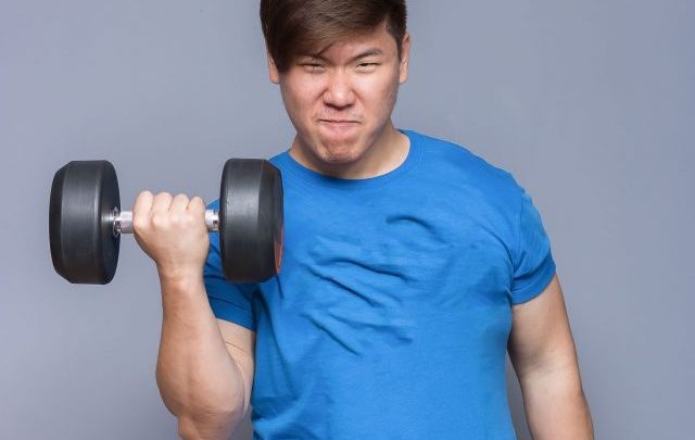 A young man lifting weights.jpg