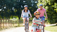 Asian family cycling together