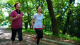 Two senior woman running in a park