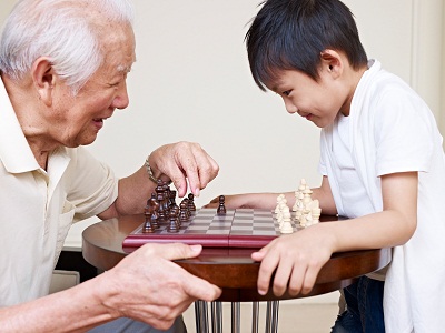Elderly grandfather spending time with his grandson