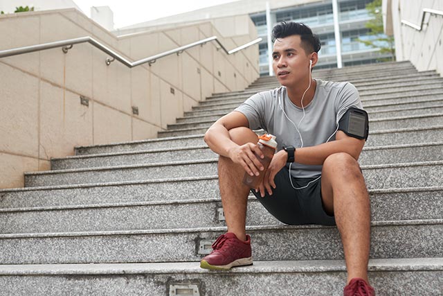 Man resting at the stairs after a workout