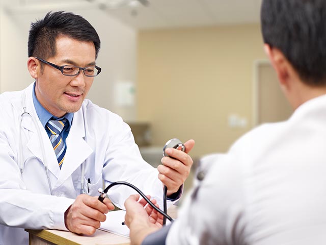 Doctor measuring the blood pressure of a patient