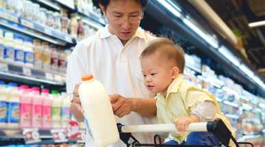 asian-father-cute-toddler-choosing-milk-product-in-grocery-store.jpg