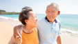 A senior couple walking together on the beach
