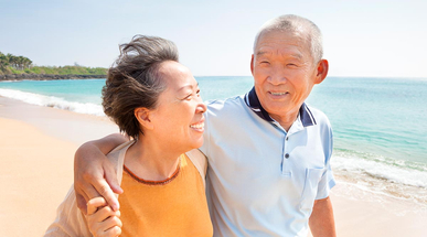 happy-asian-seniors-walking-on-the-beach.jpg