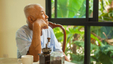 Senior man sitting at a table and thinking about things