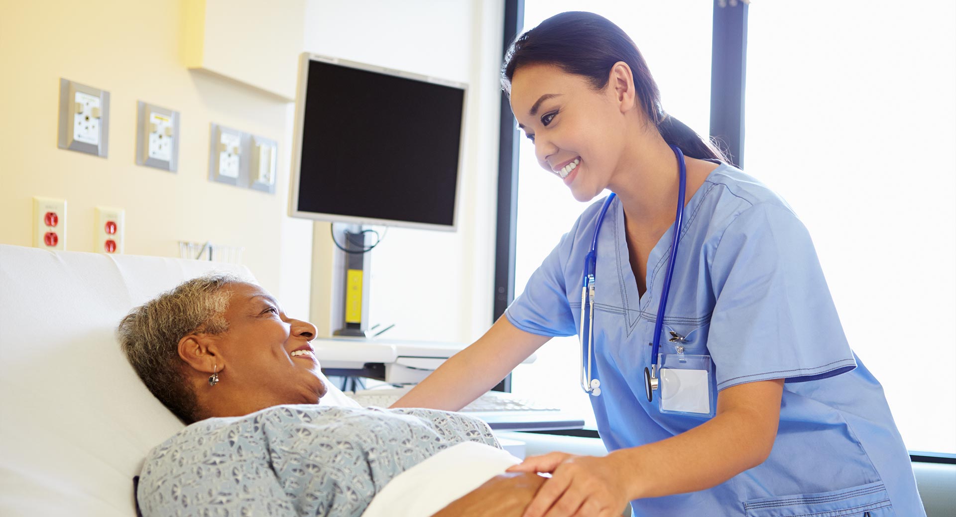 nurse-talking-to-senior-woman-in-hospital-room-feature.jpg