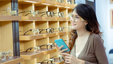 A young lady browsing frames at an optical shop