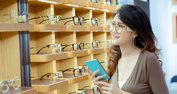 A young lady browsing frames at an optical shop
