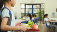 Young kids having lunch in kindergarten