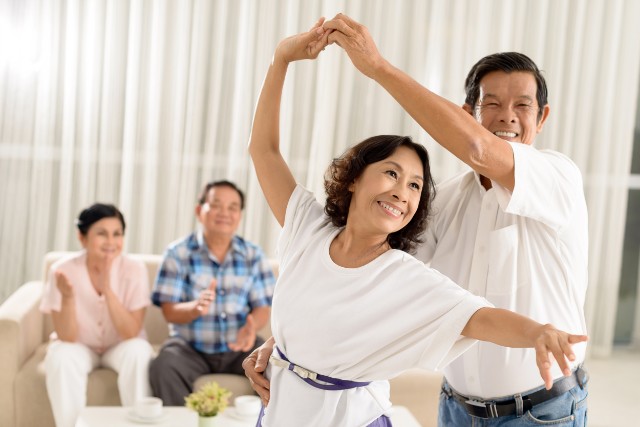 asian elderly couple dancing together