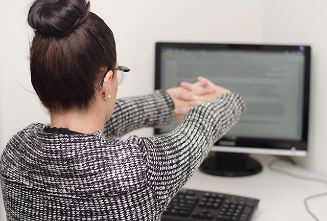 Straighten your arms and stretch at your work desk.