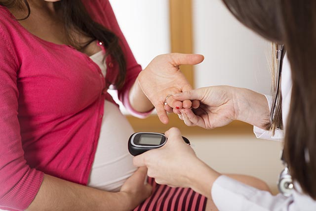 Pregnant mother getting a blood sugar test