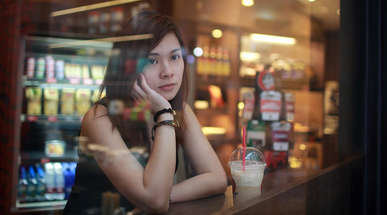 young-girl-looking-out-behind-the-cafe-window.jpg