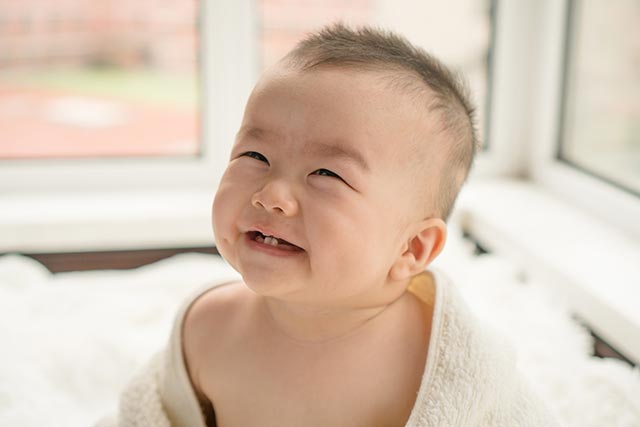 Young baby wrapped in a tower after a bath