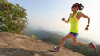 Athletic young girl running on a mountain