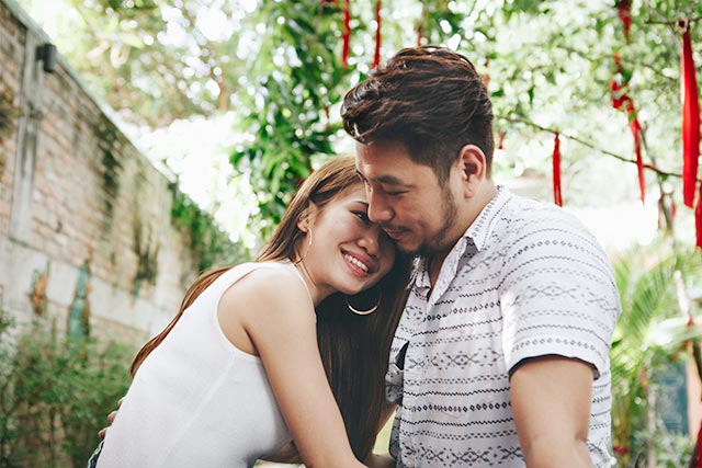 A young couple looking at each other lovingly while the girl rests her head on the guy's shoulder