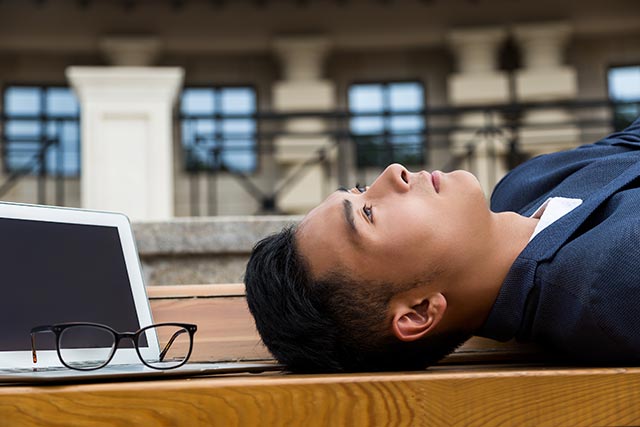 Man lying down and not getting enough physical activity.