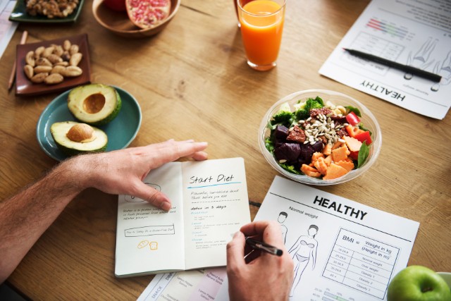 Planning a healthy diet plan with healthy food on the table.
