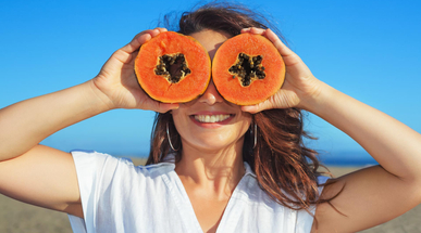adult-woman-hold-in-hands-ripe-fruit-orange-papaya.jpg