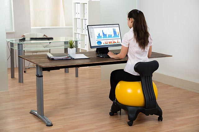 Use an exercise ball chair to activate your core and upper body.