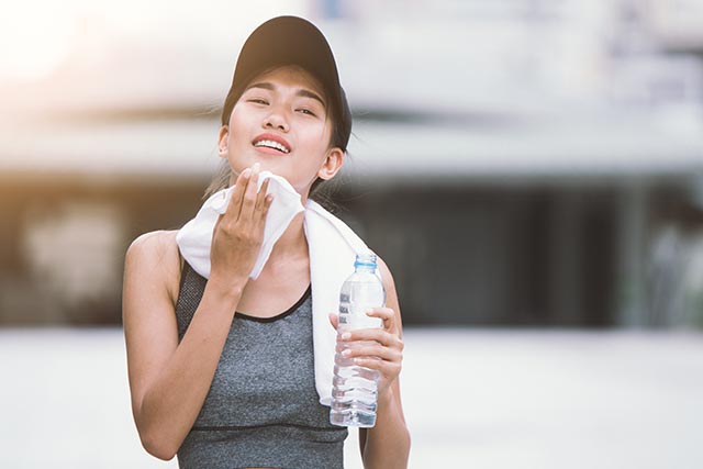 Female jogger wiping her sweat after having a run
