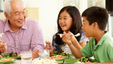 Asian family eating a meal together