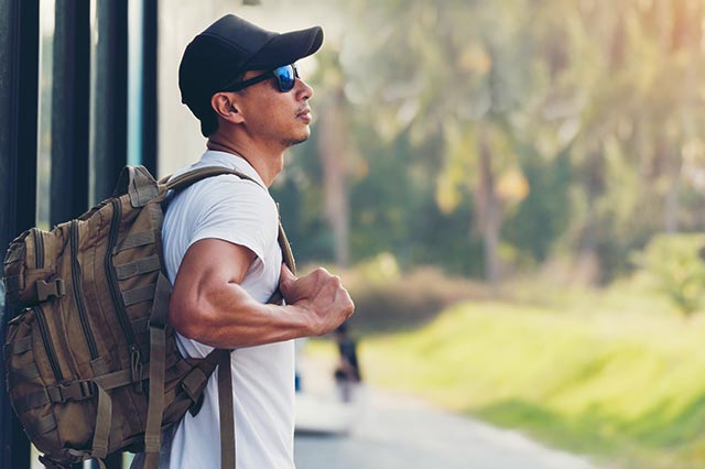 Man with heavy backpack hiking.