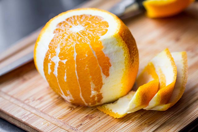 A freshly cut orange on a chopping board