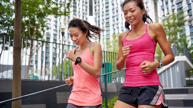 young women running outdoors to boost metabolism