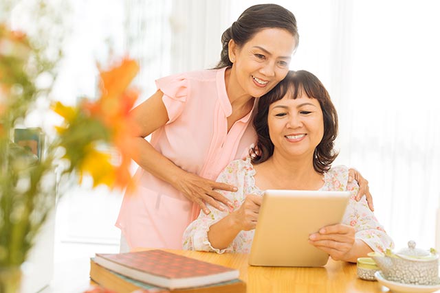 Two elderly women encouraging each other to go for mammogram screening