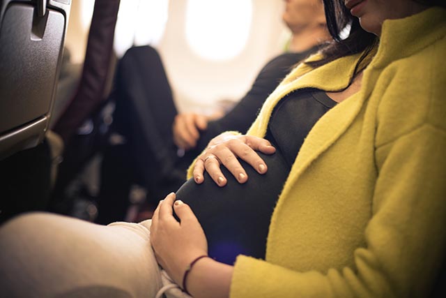 Pregnant mother travelling in an airplane