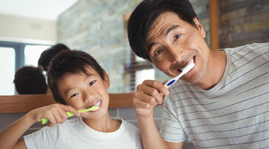 father-and-son-brushing-teeth-in-the-bathroom.jpg