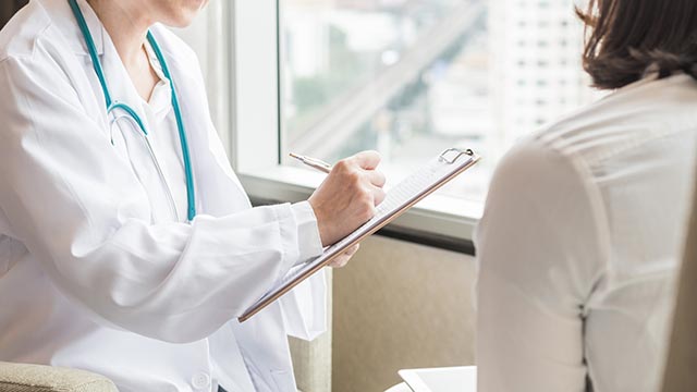 Doctor examining a patient's medical records during an appointment