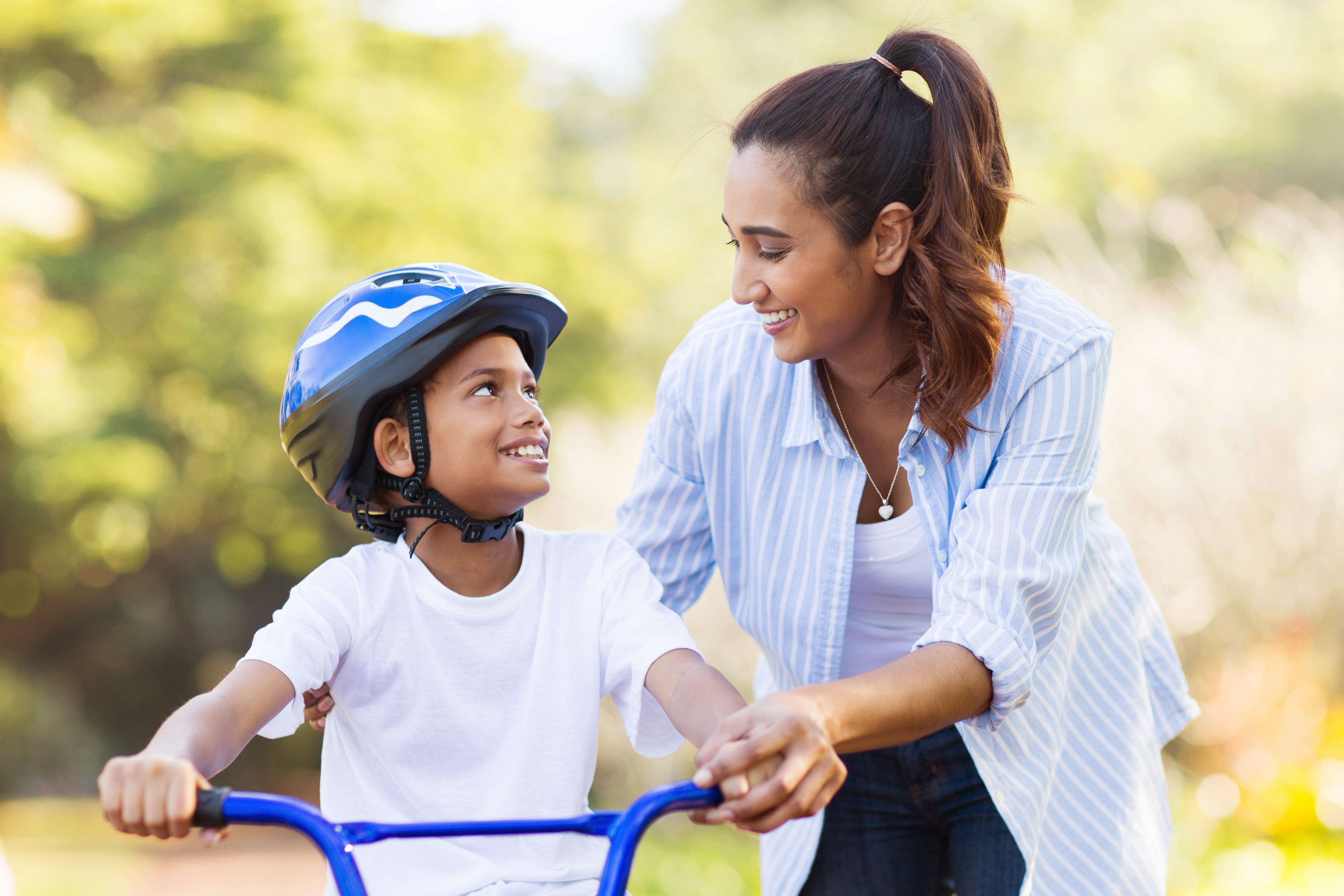 Kid and parent riding a bike