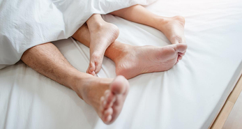 Young asian couple lying together in bed