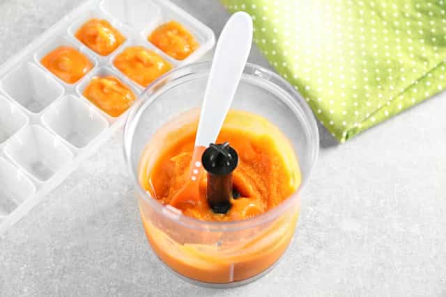 baby food puree in a small cup with a baby spoon, and also in ice cube trays. You can freeze baby food puree in an ice tray when feeding your baby weaning foods.>