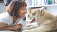 Woman spending time with her dog, which helps to improve her emotional health.