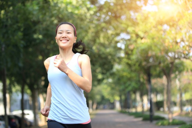 asian woman running at the park