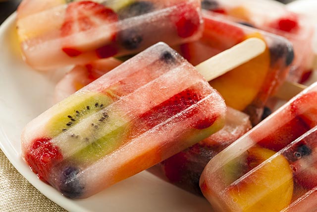 fruit slices frozen in an ice popsicle