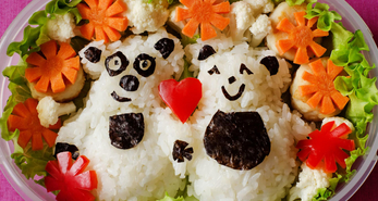 Healthy meals for kids in bento boxes prepared with fresh ingredients.