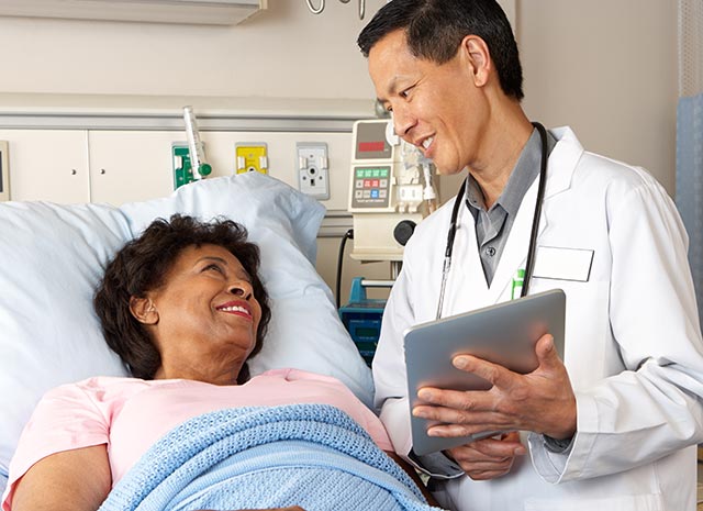 A person with dementia with Lewy bodies in the hospital getting advice from a doctor.