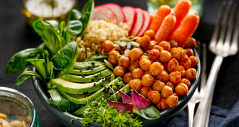 Healthy Buddha Bowl consisting of avocado and mixed vegetables