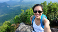 A hiker on a mountain range enjoying the health benefits of hiking.