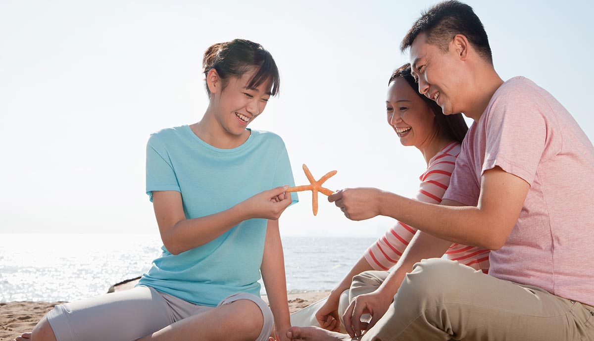 family-sitting-on-the-beach.jpg