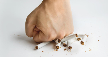 A man crushing cigarettes with his fist
