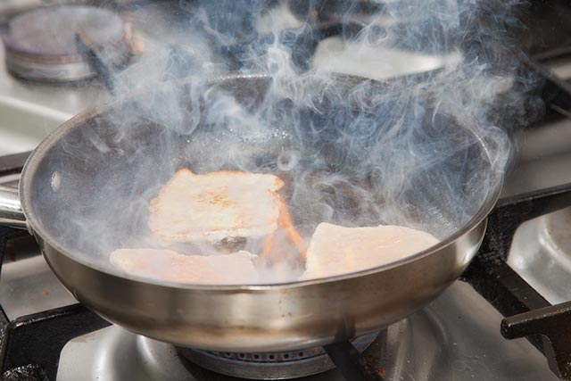 oil smoking in a pan that is cooking