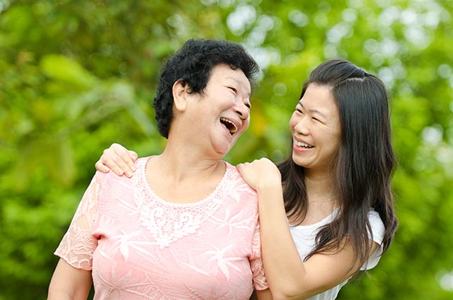 Mother-daughter duo smiling after brisk walking outdoors