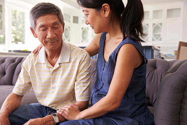  A daughter comforting her father as his dementia progresses.